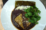 Figure 30. Cuitlacoche is served in soups, appetizers, and entrees at many fashionable Mexican restaurants in major metropolitan areas in the U.S., such as Rick Bayless's Frontera Grill/Topolobampo in Chicago: (a, top) red chile braised mushrooms with cuitlacoche, roasted chayote and corn masa dumplings. (b, middle) pork tamales cooked in banana leaves with silky mulato chile cuitlacoche sauce, black beans and watercress salad. (c, right) green chile crepes filled with cuitlacoche, roasted vegetables and serrano chile over a green chile pepita sauce with squash blossom salad. (Courtesy Tracey Vowell, consulting chef, Frontera Grill.) 